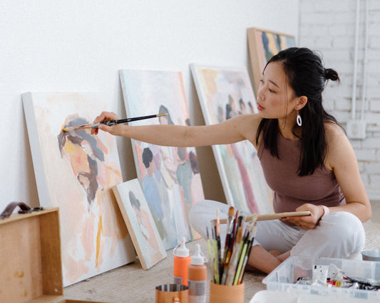 Christian Artist Joy Gonzales painting on a canvas