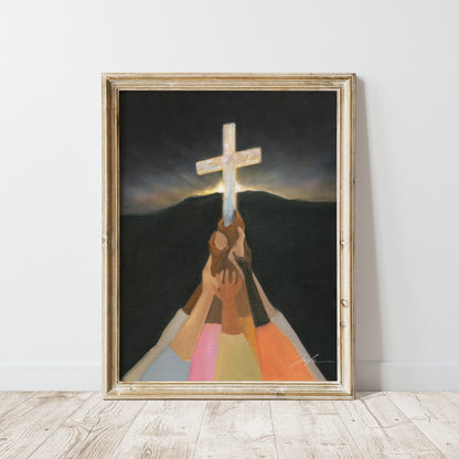Christian wall art print of diverse colorful hands lifting up the cross in darkness, with a dark mountain and morning light rising behind it.