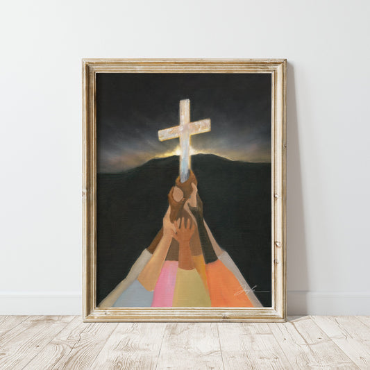 Christian wall art print of diverse colorful hands lifting up the cross in darkness, with a dark mountain and morning light rising behind it.