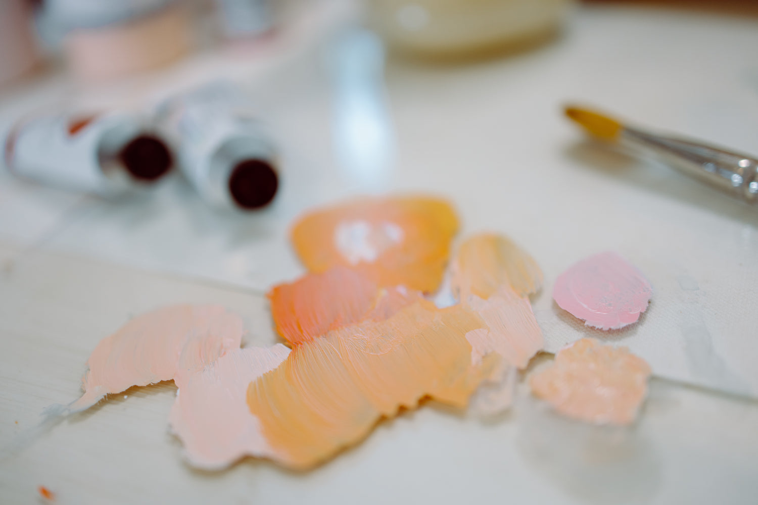 Christian artist studio scene of paints and a brush on a painting station