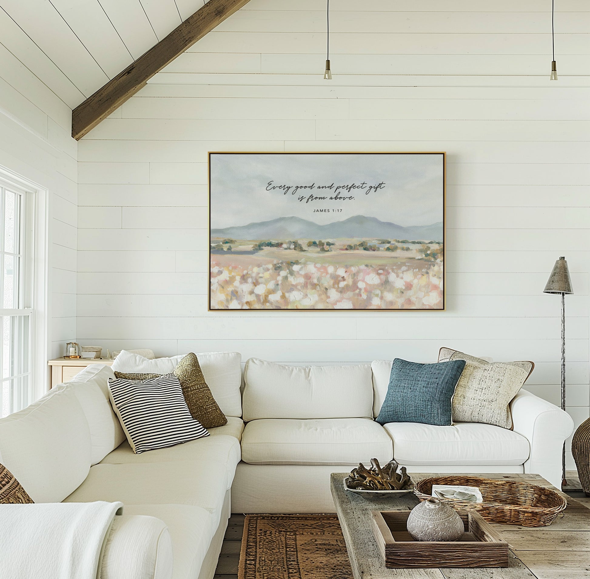 Framed Christian art of Floral field landscape wall art with mountains in the distance featuring James 1:17 Scripture, displayed in living room