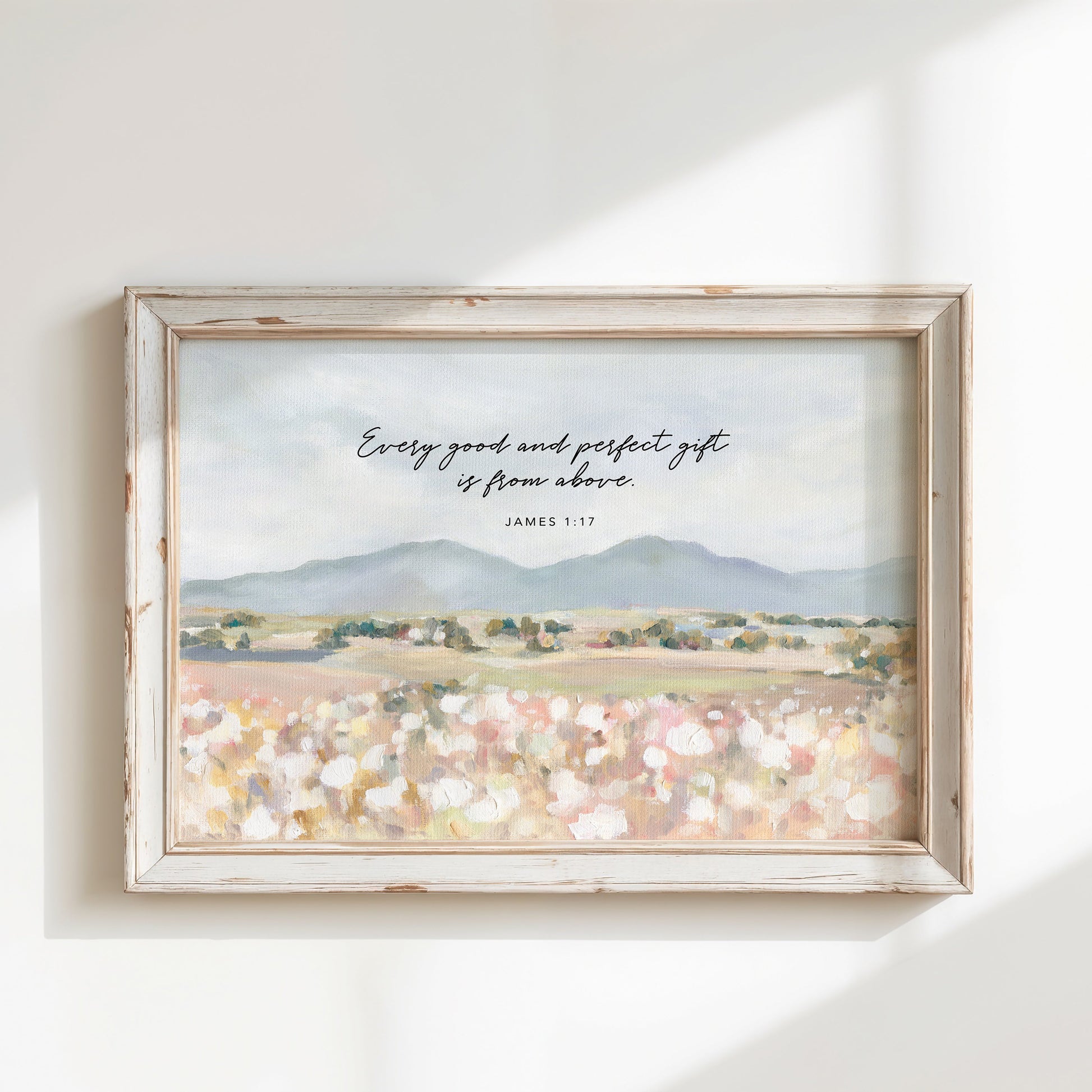 Framed Christian art of Floral field landscape wall art with mountains in the distance featuring James 1:17 Scripture