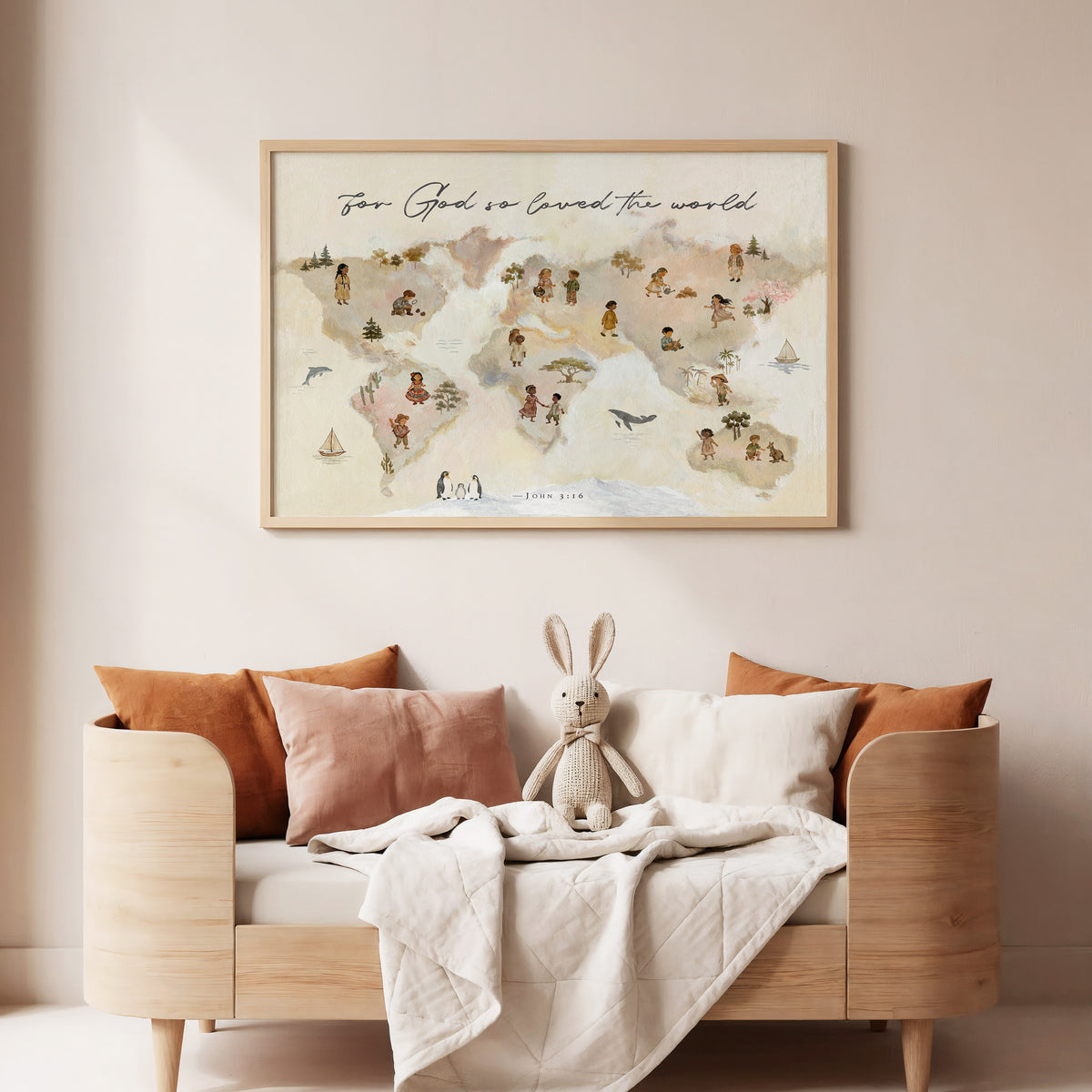 A framed world map art print hangs on a beige wall above a light wood daybed styled with orange and blush pillows, a white quilt, and a stuffed bunny.