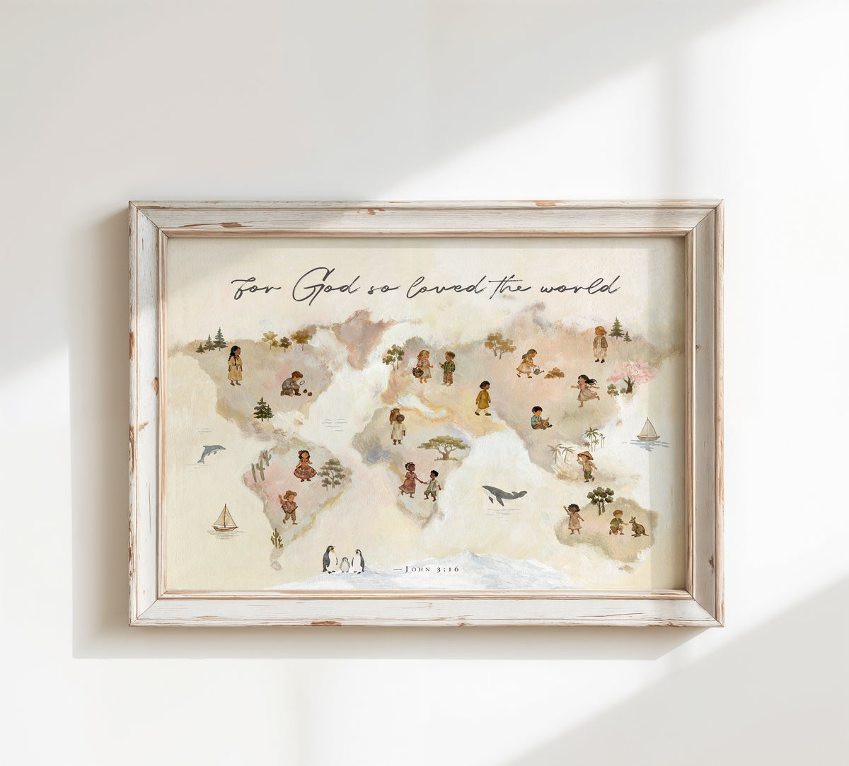 Framed world map wall art with a distressed white wood frame, hanging on a white wall. The map illustration is in soft pastel tones with small figures and landmarks, and the text 'For God we loved the world' appears at the top.