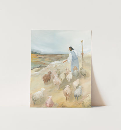Unframed Jesus the Good Shepherd art print displayed against a white wall in soft neutral tones.