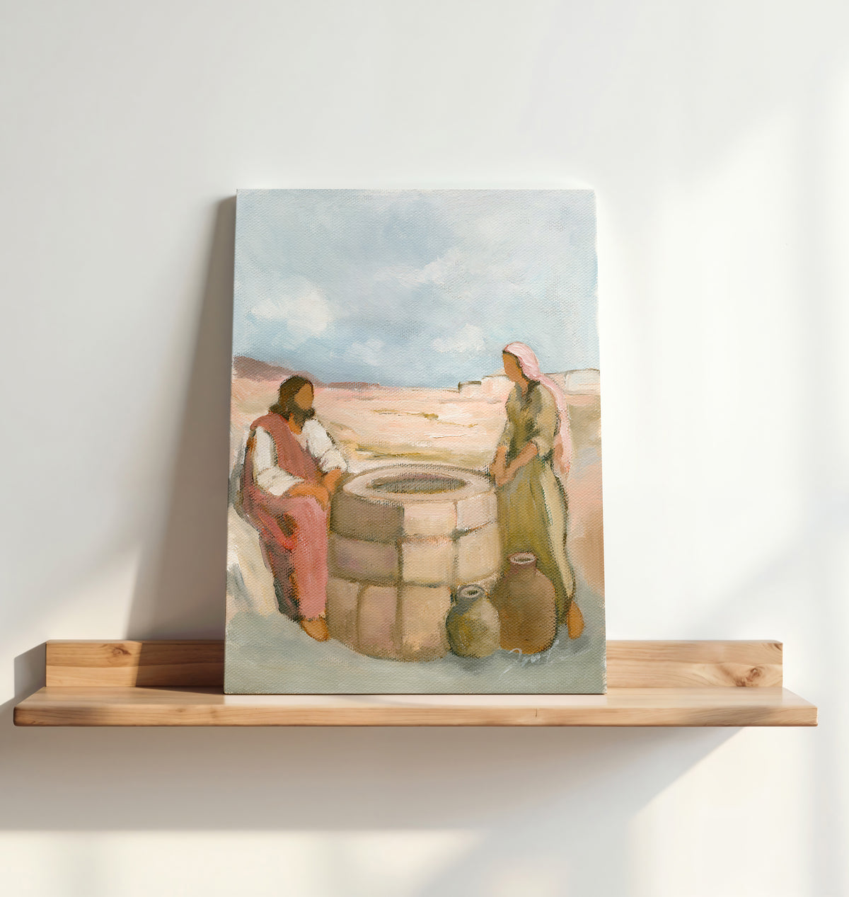 Unframed Jesus and the Samaritan woman art print displayed on a wooden shelf in warm natural light.