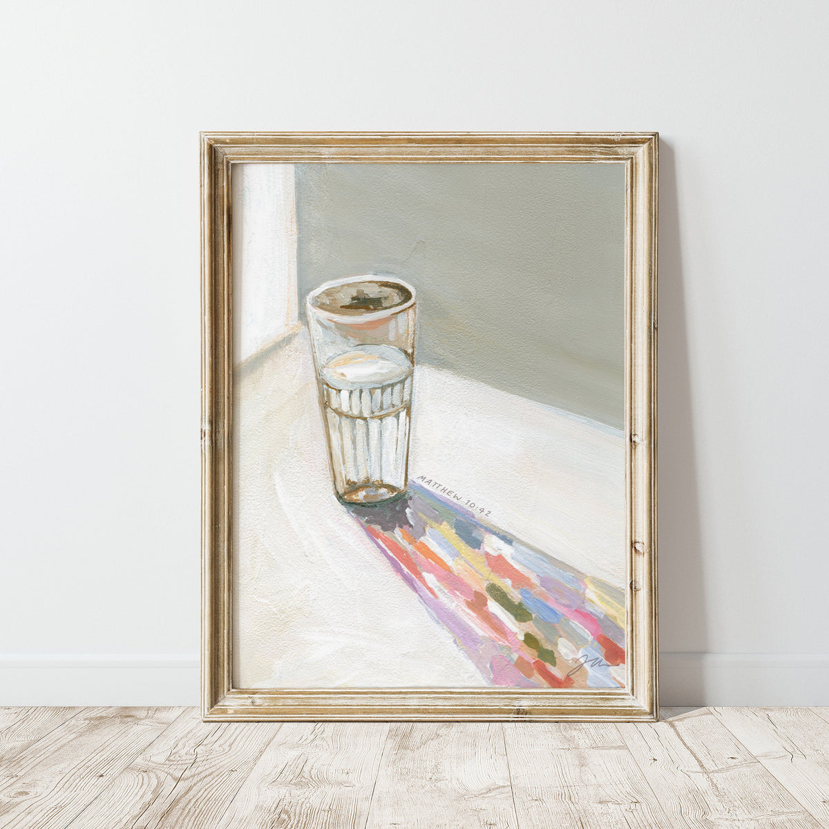 Framed art print of a Painting of a glass of water casting a long colorful shadow, with Matthew 10:42 written beside it.